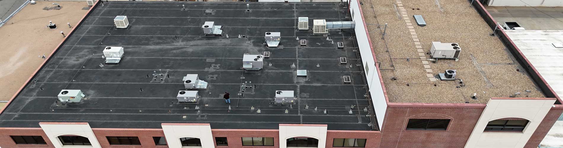 Aerial view of commercial flat roof with HVAC units - ARCM Roofing Denver